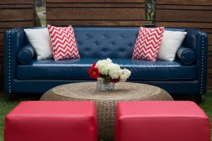 Navy sofa with red pillows